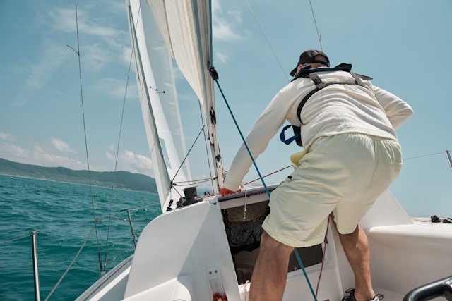 a-man-standing-on-the-bow-of-a-sailboat